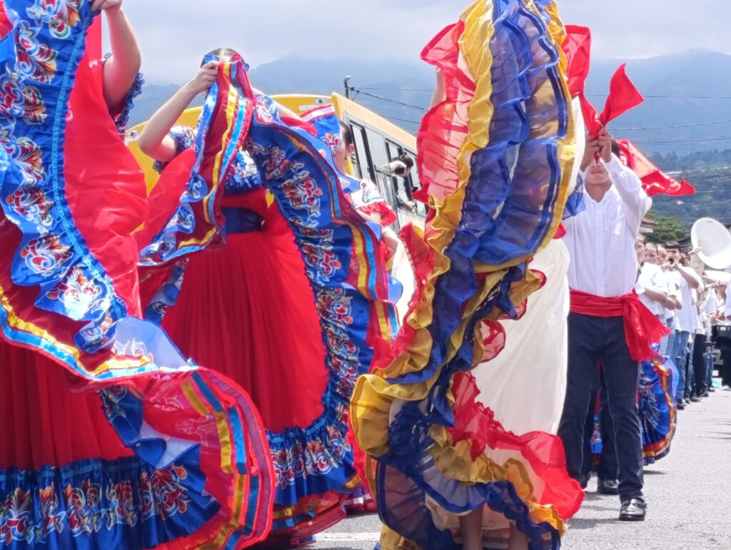 Costa Rican folk dancers in traditional dress during a parade in Sarchí